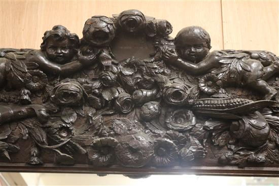 A Victorian heavily carved and painted oak overmantel W.150cm